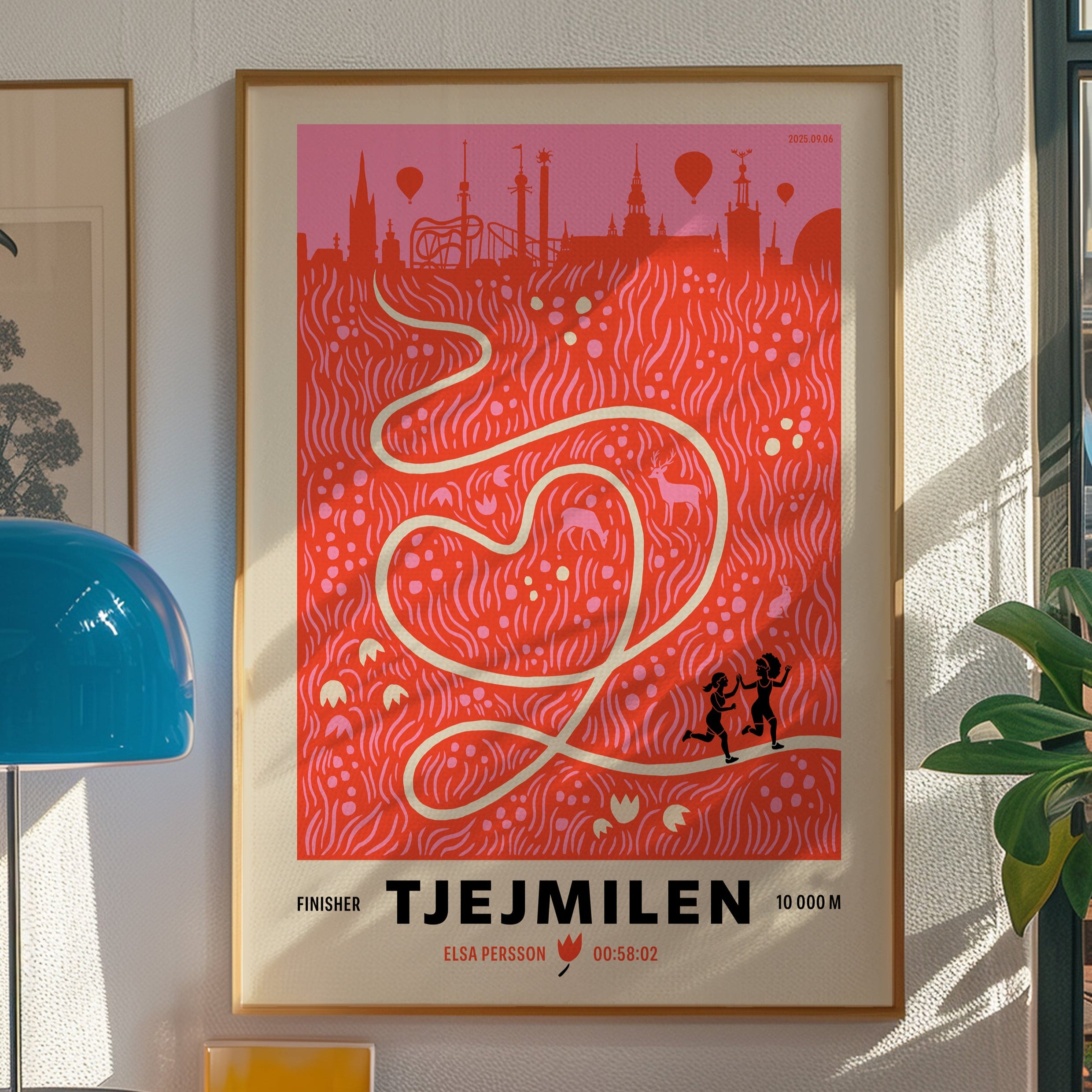 Framed poster with a red design and text on a wall in a room with decor elements.